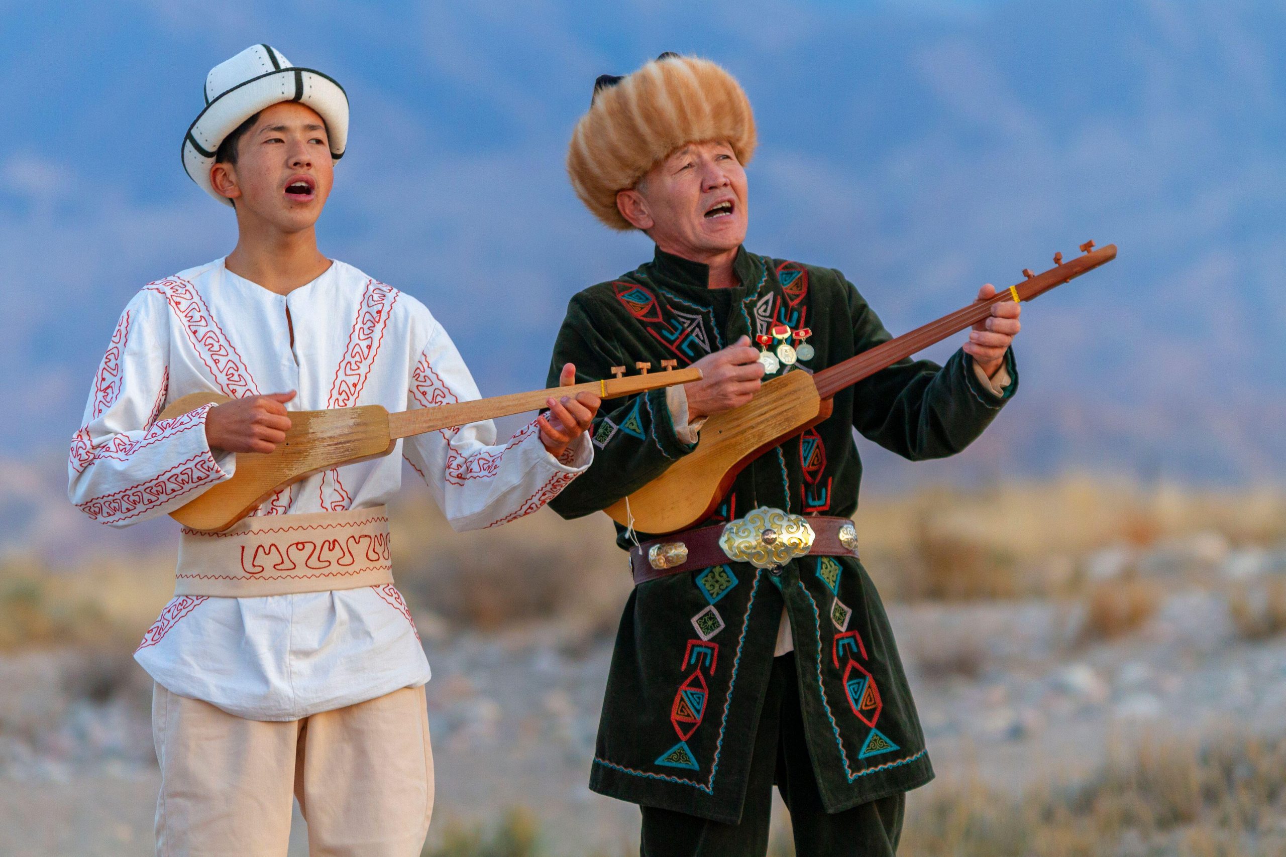 Kyrgyz Musicians Playing The Komuz A Traditional Musical Instrument In